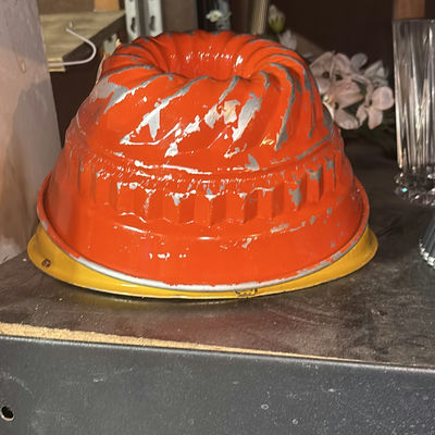 Assorted glassware with burgundy wine glass, red candle, and orange ridged baking mold - Image 1 of 8