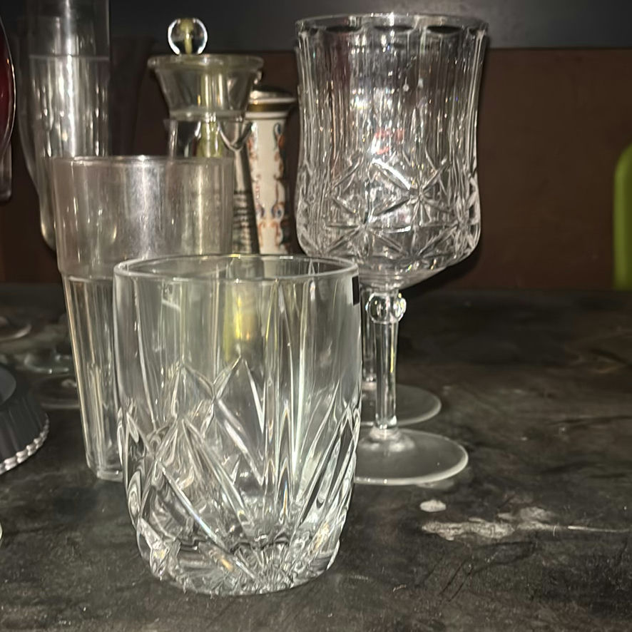 Assorted glassware with burgundy wine glass, red candle, and orange ridged baking mold - image 4 of 8