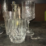 Assorted glassware with burgundy wine glass, red candle, and orange ridged baking mold - thumbnail 4 of 8