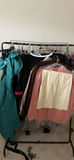 Assorted women's dresses and jackets on a garment rack - thumbnail 1 of 8