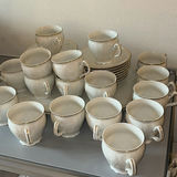 Porcelain dinnerware set with gold-edged plates, bowls, saucers, and cups - thumbnail 9 of 9