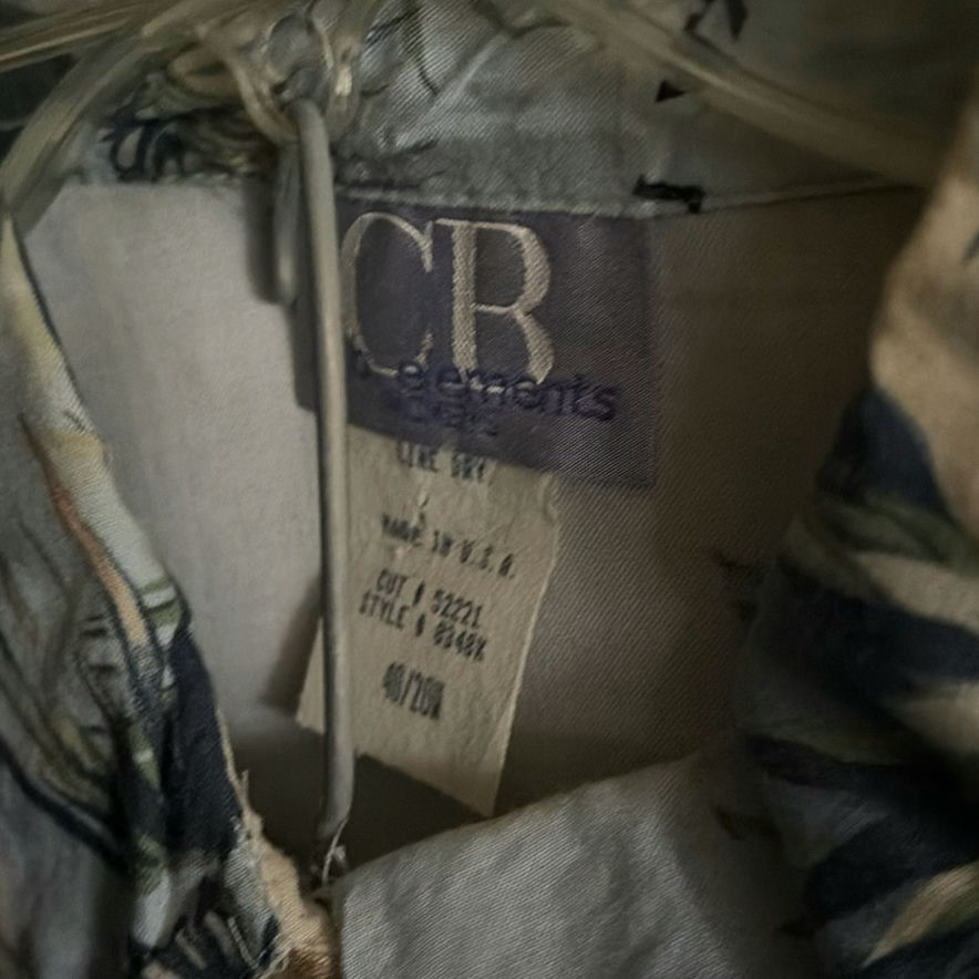 Assorted shirts and blouses on closet hangers - image 4 of 5