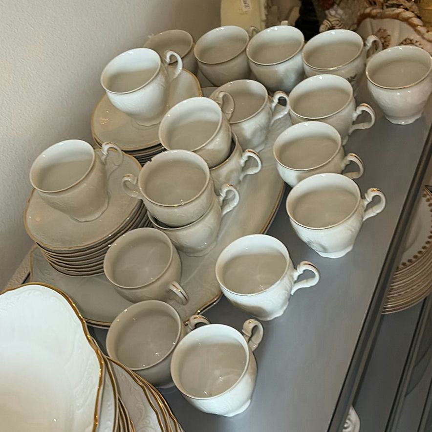 Porcelain dinnerware set with gold-edged plates, bowls, saucers, and cups - image 7 of 9