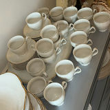 Porcelain dinnerware set with gold-edged plates, bowls, saucers, and cups - thumbnail 7 of 9