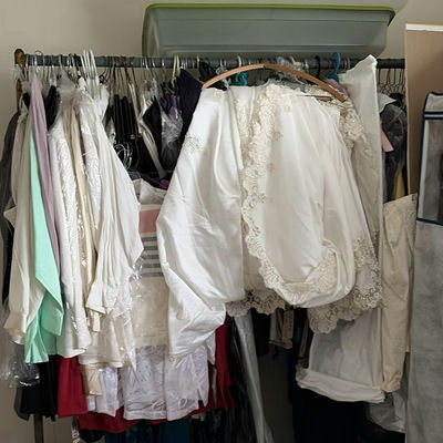 White bridal gowns and formal wear on hangers - Image 1 of 4