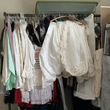 White bridal gowns and formal wear on hangers - thumbnail 1 of 4