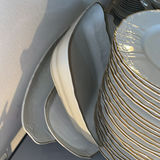 Porcelain dinnerware set with gold-edged plates, bowls, saucers, and cups - thumbnail 4 of 9