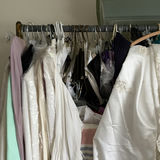 White bridal gowns and formal wear on hangers - thumbnail 2 of 4