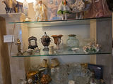 Vintage glassware and porcelain figurine collection on glass shelves - thumbnail 3 of 5
