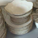 Porcelain dinnerware set with gold-edged plates, bowls, saucers, and cups - thumbnail 6 of 9