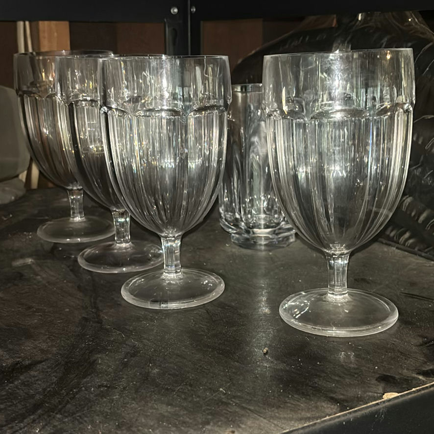 Assorted glassware with burgundy wine glass, red candle, and orange ridged baking mold - image 7 of 8