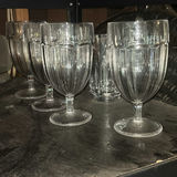 Assorted glassware with burgundy wine glass, red candle, and orange ridged baking mold - thumbnail 7 of 8