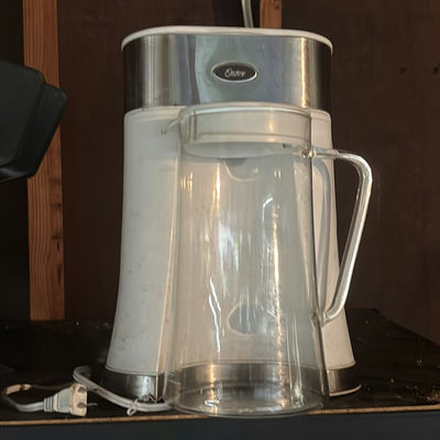 Oster coffee maker with glass carafe, utensil jar, and bead storage organizer - Image 1 of 4