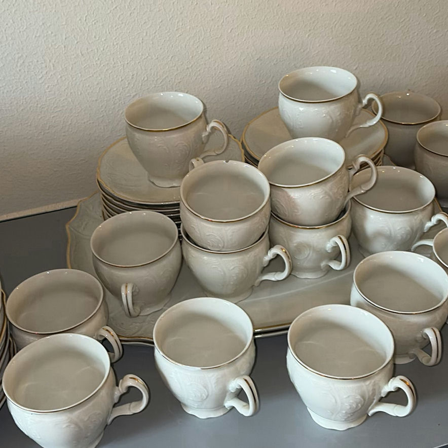 Porcelain dinnerware set with gold-edged plates, bowls, saucers, and cups - image 8 of 9