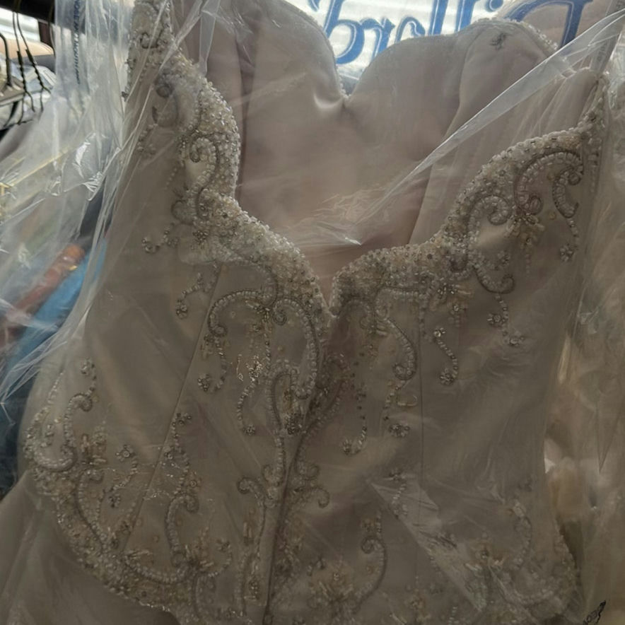 Wedding dress and assorted clothing on a garment rack - image 10 of 15