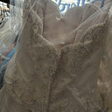 Wedding dress and assorted clothing on a garment rack - thumbnail 10 of 15