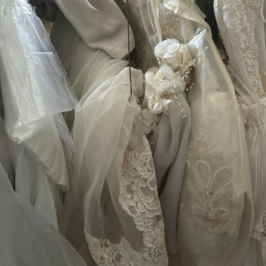 Wedding dress and assorted clothing on a garment rack - image 12 of 15