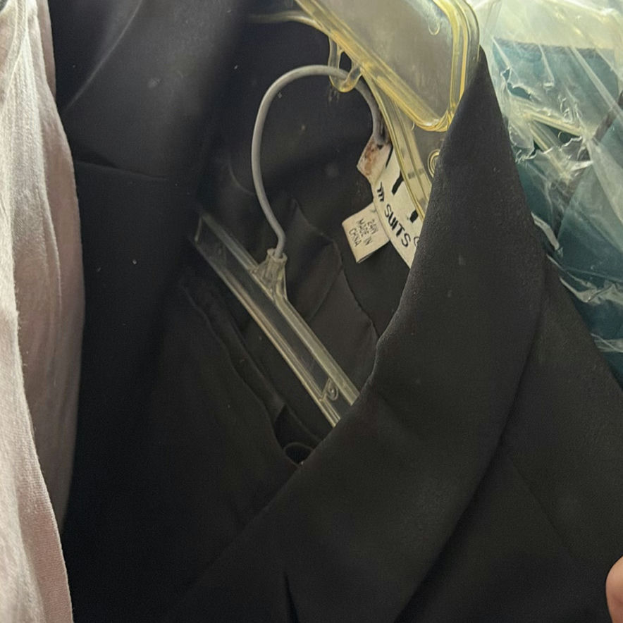 Wedding dress and assorted clothing on a garment rack - image 13 of 15