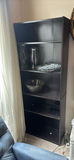Tall black bookshelf with glassware - thumbnail 1 of 3
