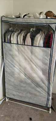 Fabric wardrobe with hanging clothes and hats - Image 1 of 6