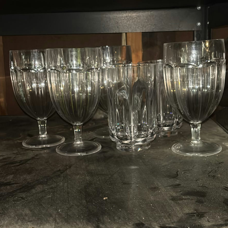 Assorted glassware with burgundy wine glass, red candle, and orange ridged baking mold - image 8 of 8