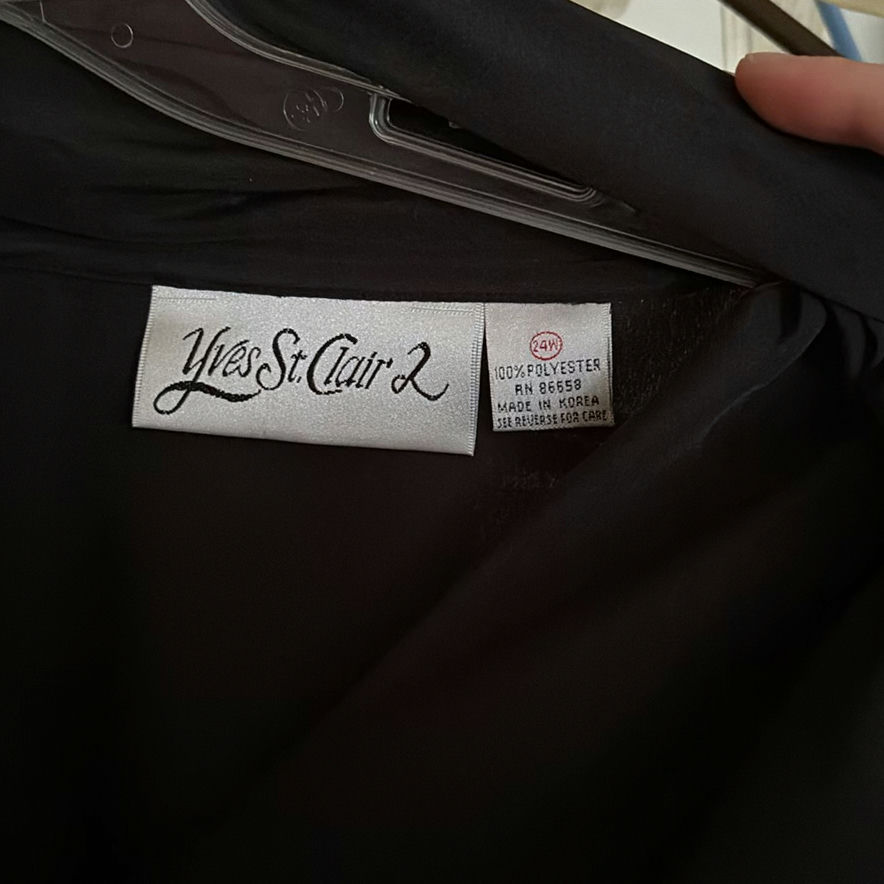 Assorted women's clothing on a clothes rack - image 2 of 5