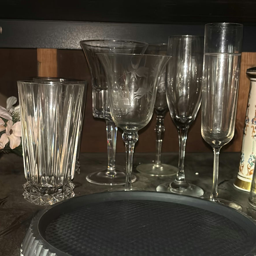 Assorted glassware with burgundy wine glass, red candle, and orange ridged baking mold - image 2 of 8