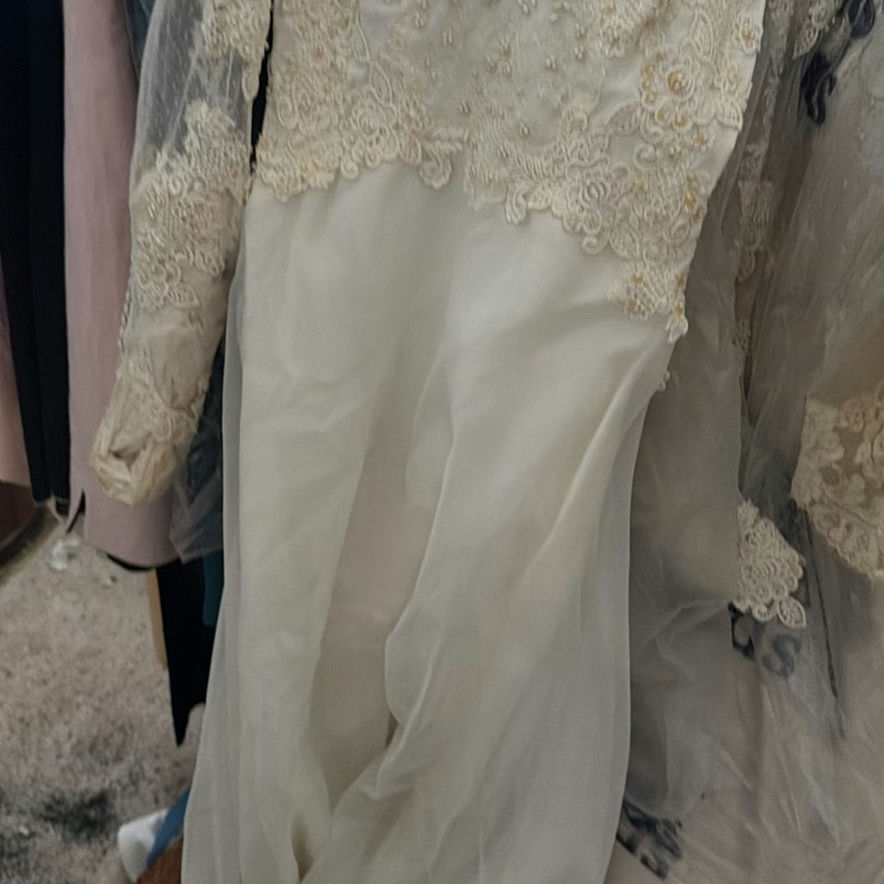 Wedding dress and assorted clothing on a garment rack - image 9 of 15