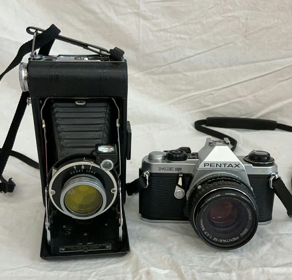 Two vintage film cameras: Kodak Vigilant Junior Six-20 folding camera and Pentax ME Super 35mm SLR - image 1 of 6