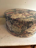 Round tapestry hatbox with blue and yellow hats - thumbnail 3 of 4