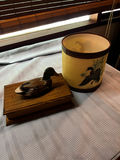 Duck decoy on wooden display stand and hand-painted ceramic bird cylinder - thumbnail 1 of 3