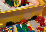 A yellow plastic school bus loaded with a bag of assorted colorful legos. - thumbnail 5 of 6