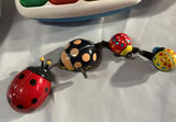 Assorted Fisher-Price infant toys: stacking star, colorful piano, bead spinner with clown, and insect bead chain - thumbnail 5 of 5