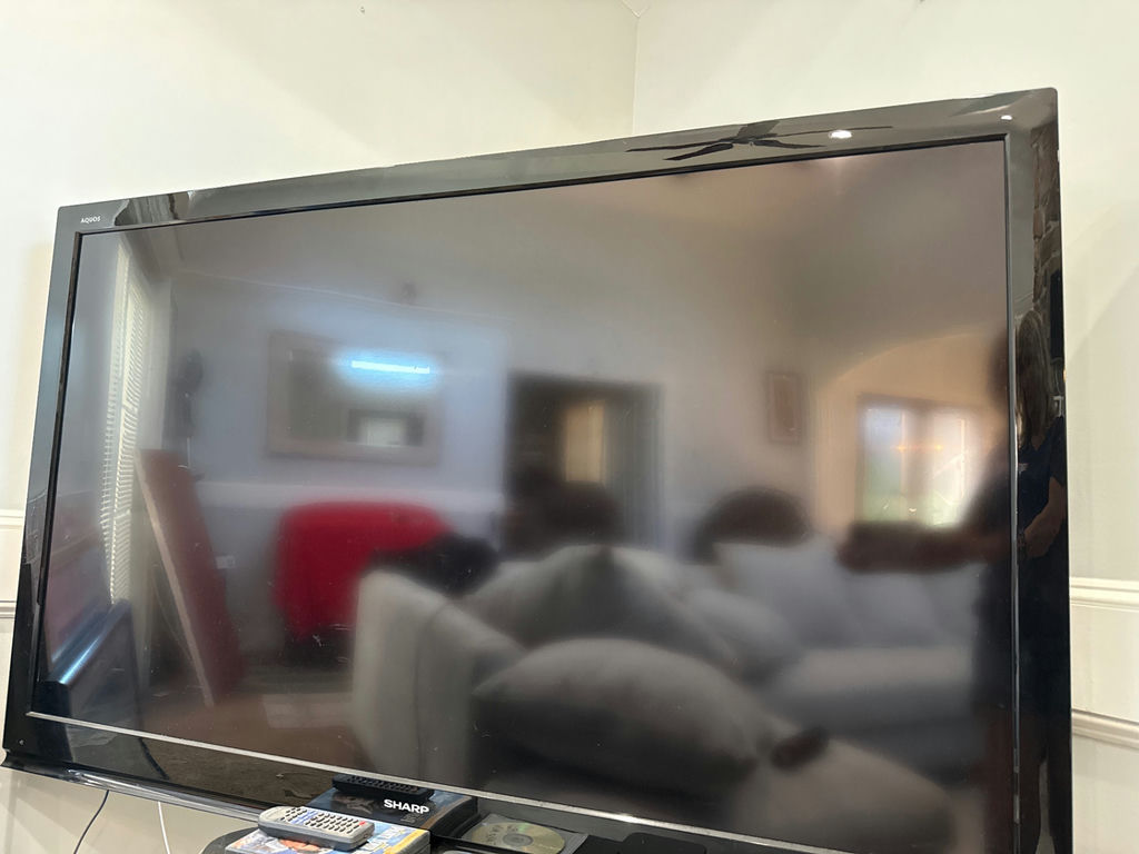Sharp AQUOS flat-screen TV with remotes and media discs - image 1 of 4