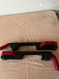 Pair of black plastic bar clamps with red handles - thumbnail 2 of 3