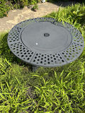 Round gray metal firepit with perforated edge and inner grate - thumbnail 1 of 3
