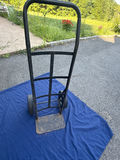 Two-wheeled black hand truck with base plate - thumbnail 1 of 2