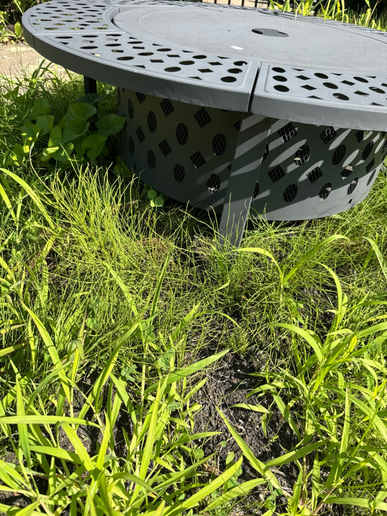 Round gray metal firepit with perforated edge and inner grate - image 2 of 3