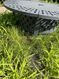 Round gray metal firepit with perforated edge and inner grate - thumbnail 2 of 3