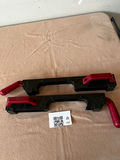 Pair of black plastic bar clamps with red handles - thumbnail 1 of 3