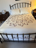 Metal bed frame with quilted floral quilt and bedside tables - thumbnail 1 of 6