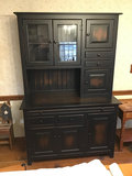 Tall black hutch cabinet with glass-front upper section - thumbnail 1 of 4