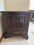 Dark wooden cabinet with double doors and bottom drawer - thumbnail 1 of 6