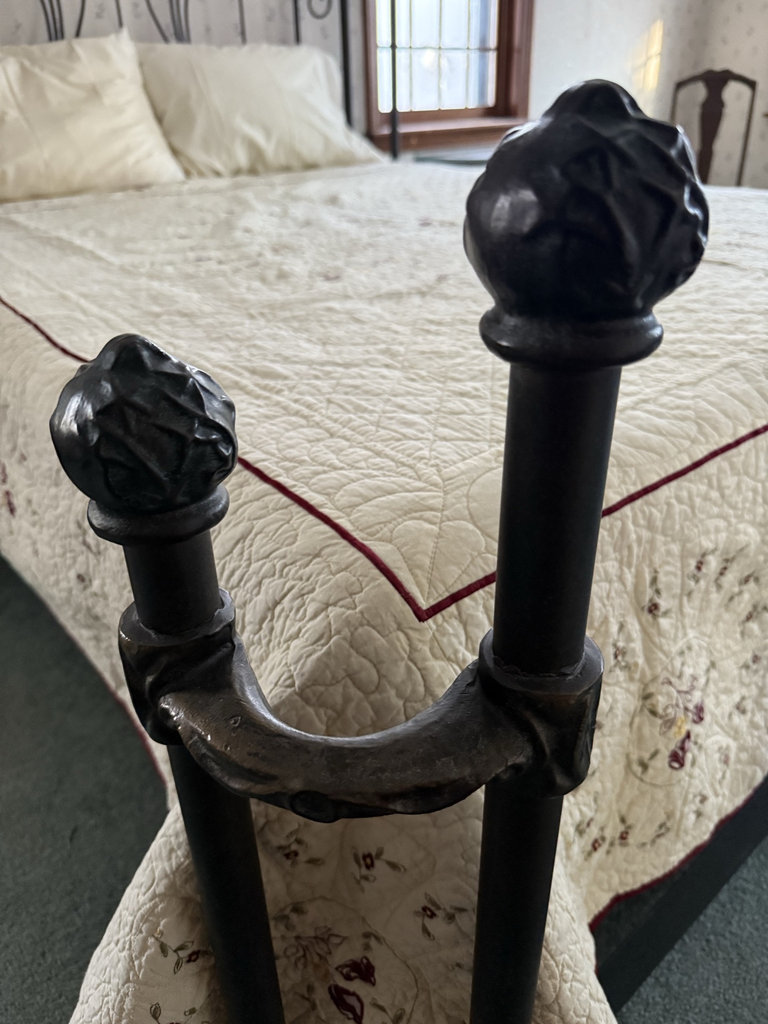 Wrought iron bed with quilted bedding - image 3 of 7