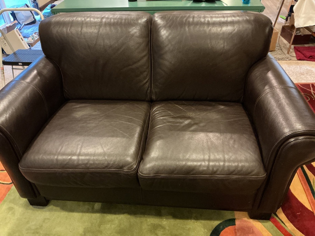 Dark brown leather loveseat with decorative pillows - image 3 of 10