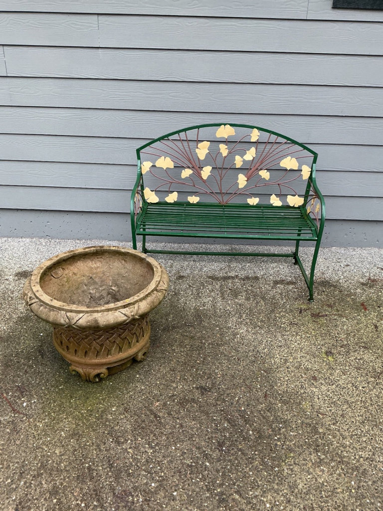 Green metal garden bench with leaf motif and large stone planter - image 1 of 6