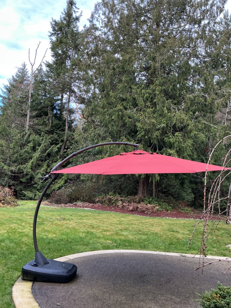 Large Red cantilever patio umbrella with base and protective sleeve - image 1 of 6