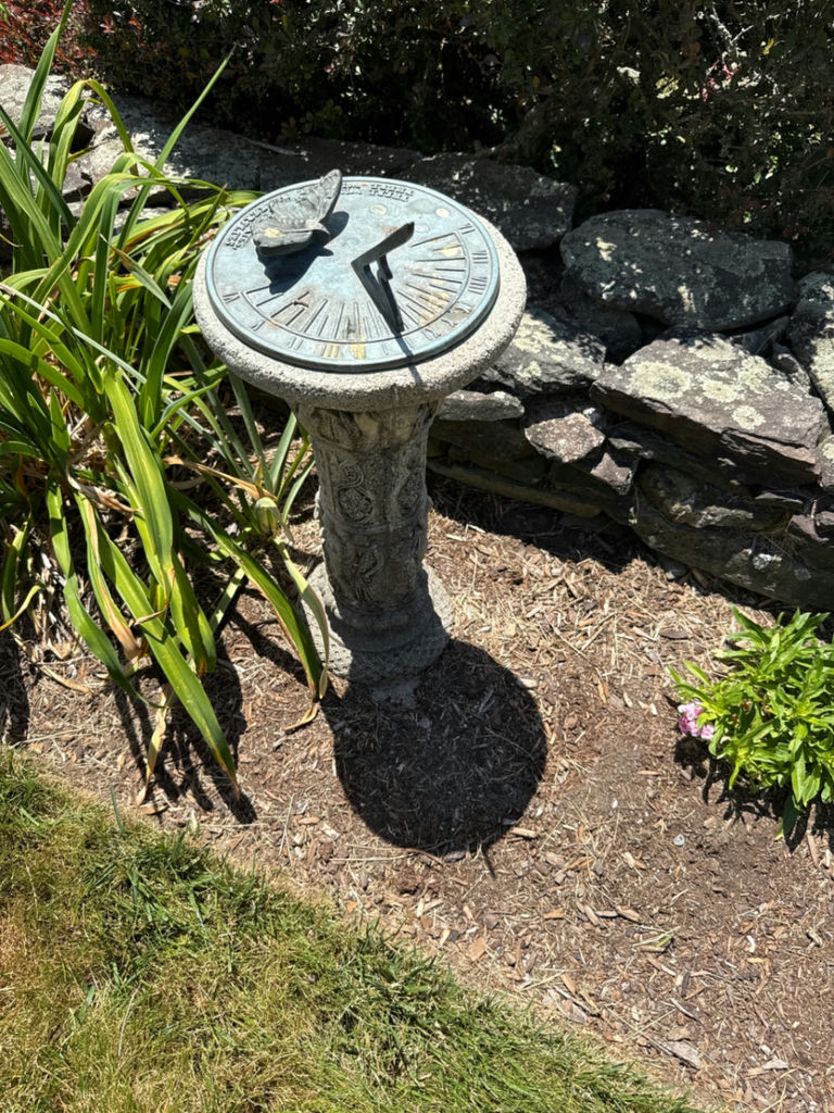 Stone sundial with butterfly motif - image 1 of 2
