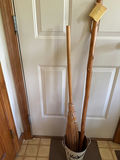 walking sticks and a broom in a metal bucket - thumbnail 1 of 4