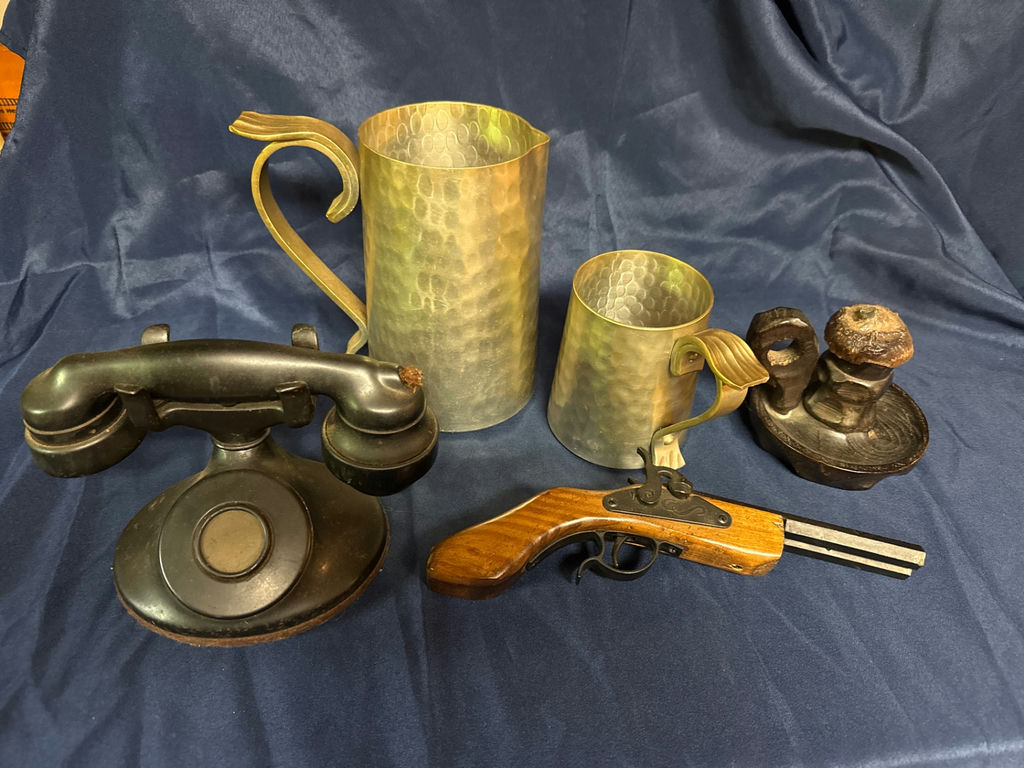 Antique hammered metal pitchers, a vintage black telephone device, and a wooden-stock pistol - image 2 of 4